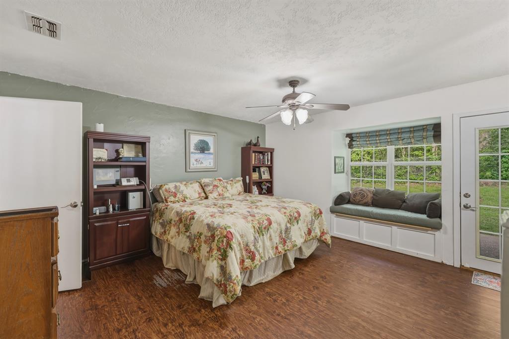 10203 Crestview Drive Tyler, TX 75707 - Photo 9 of 25 a bed room with a bed and a chandelier