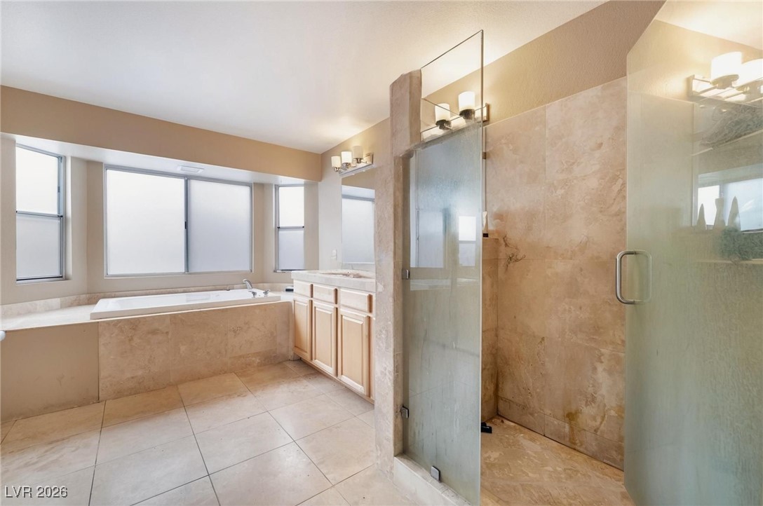 300 Redondo Street Henderson, NV 89014 - Photo 15 of 29 Full bath featuring a stall shower, vanity, a bath, and light tile patterned floors