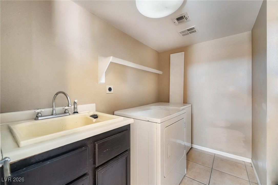 300 Redondo Street Henderson, NV 89014 - Photo 21 of 29 Laundry room featuring light tile patterned flooring and a sink