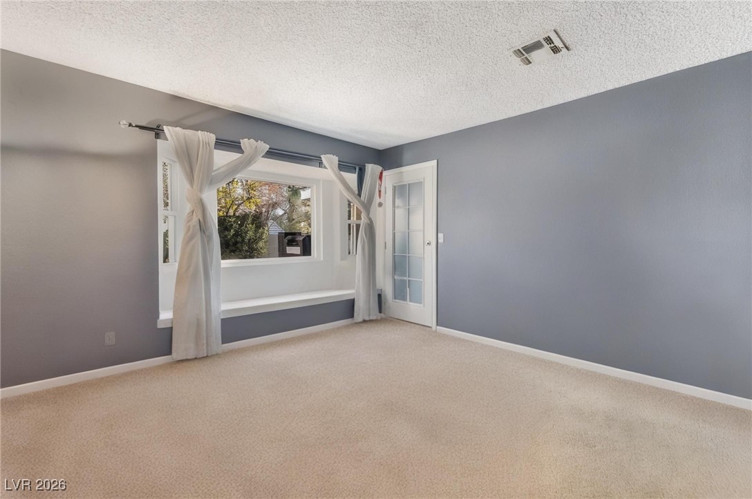 300 Redondo Street Henderson, NV 89014 - Photo 23 of 29 Carpeted empty room featuring a textured ceiling and baseboards