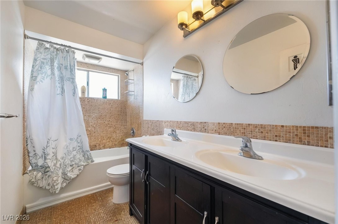 300 Redondo Street Henderson, NV 89014 - Photo 24 of 29 Bathroom with shower / tub combo, double vanity, and tile patterned floors