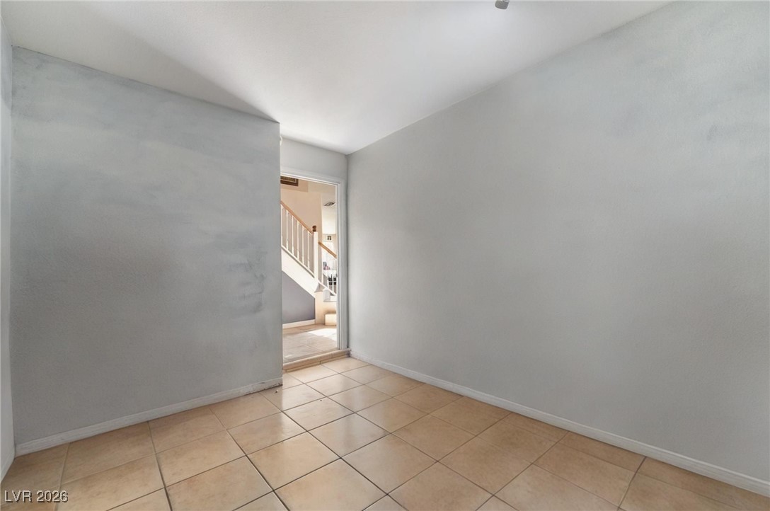 300 Redondo Street Henderson, NV 89014 - Photo 28 of 29 Unfurnished room featuring stairway and light tile patterned floors
