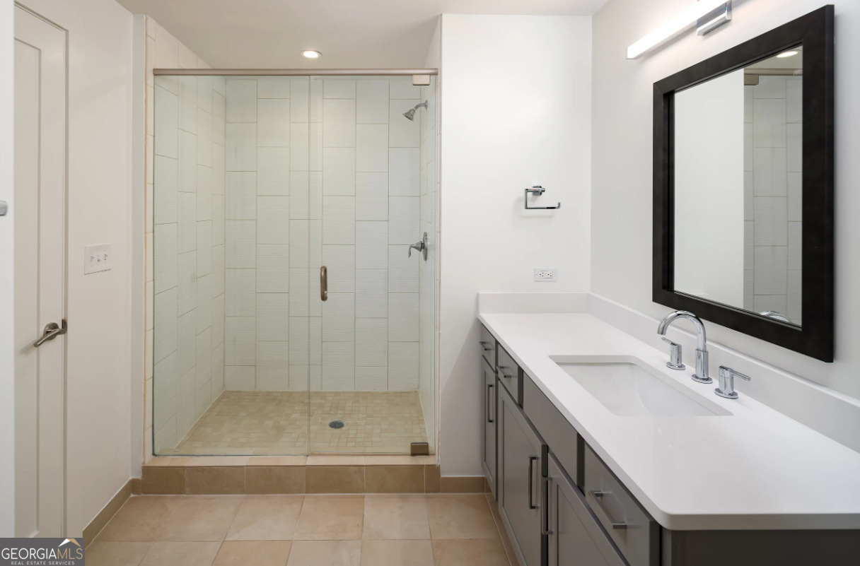 3242 Peachtree Road Northeast, Unit 1408 Atlanta, GA 30305 - Photo 18 of 41 a bathroom with a shower a sink and a mirror