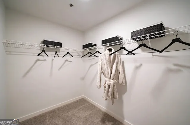 a view of a balcony with two chairs and a wooden fence