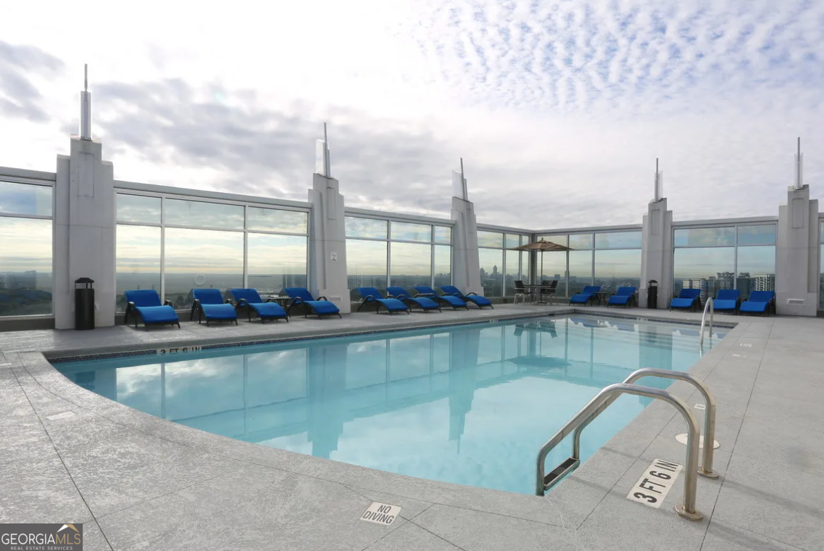 3242 Peachtree Road Northeast, Unit 1408 Atlanta, GA 30305 - Photo 28 of 41 a view of a swimming pool and outdoor seating