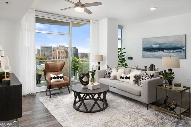 a living room with furniture and kitchen view