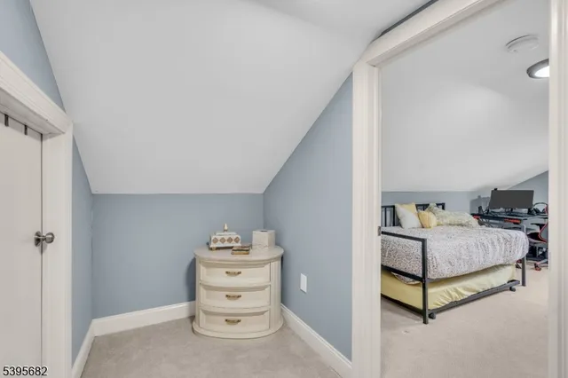 a bedroom with furniture and a large window