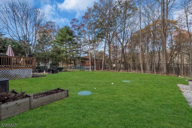 a view of a patio with a table and chairs under an umbrella