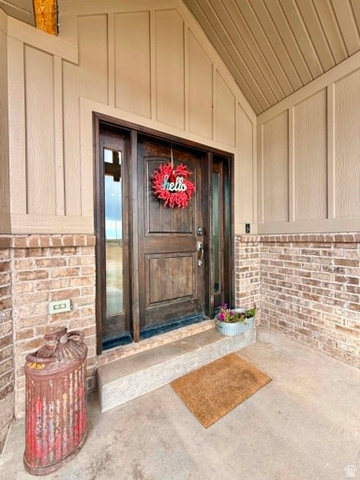 2101 Goose Ranch Road Vernal, UT 84078 - Photo 4 of 72 Craftsman-style front door with sidelights, featuring a rich wood finish