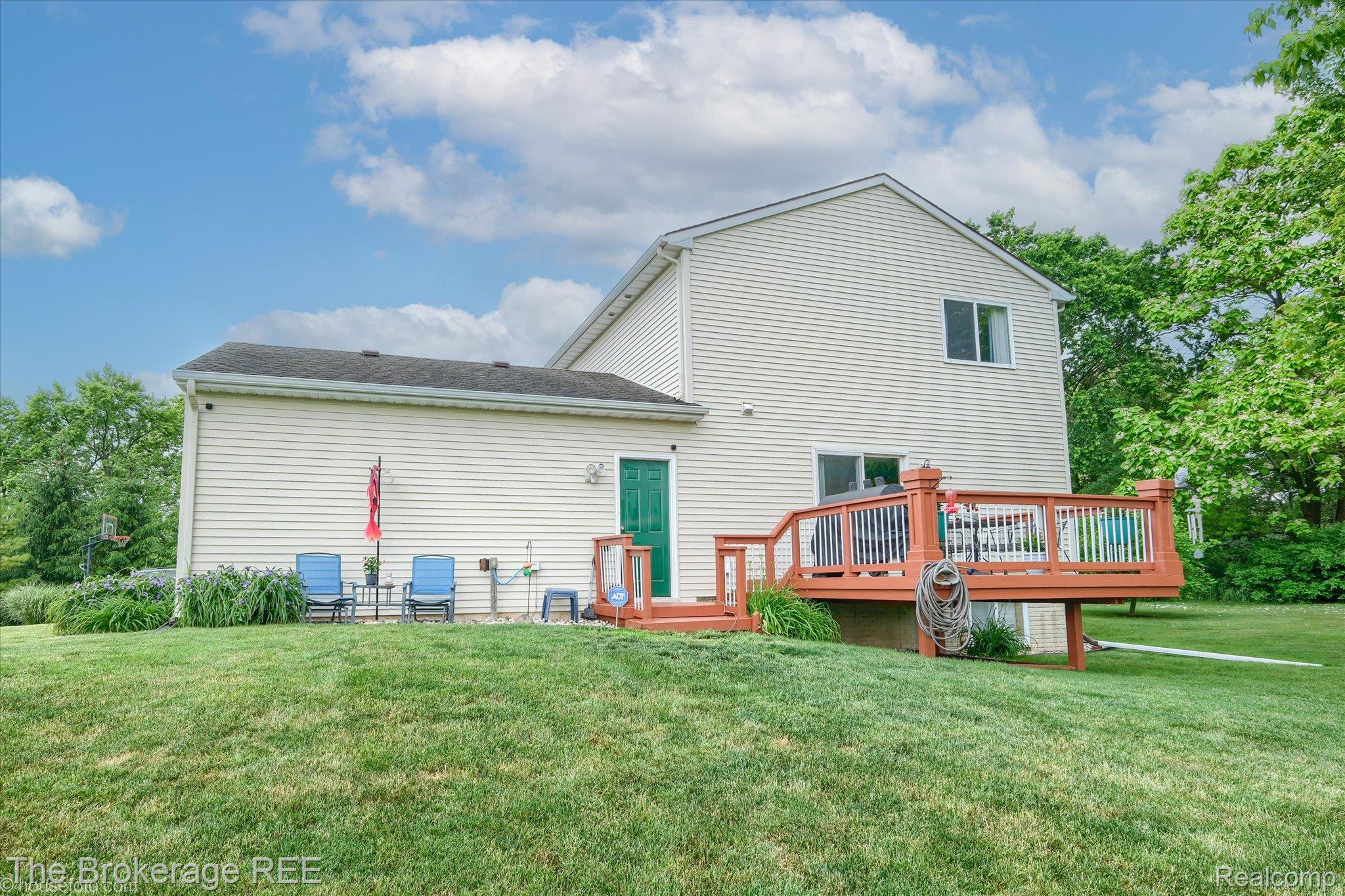 4432 North Belsay Road Flint, MI 48506 - Photo 12 of 79 Expansive green lawn with a two-story exterior featuring light-colored siding