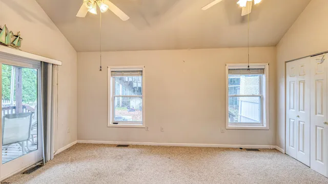 an empty room with windows and closet