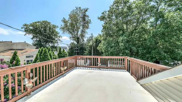 a view of a balcony with wooden fence