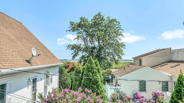 a balcony with a large window and wooden fence