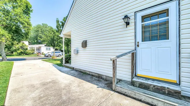 a road view with a car parked in front of the house