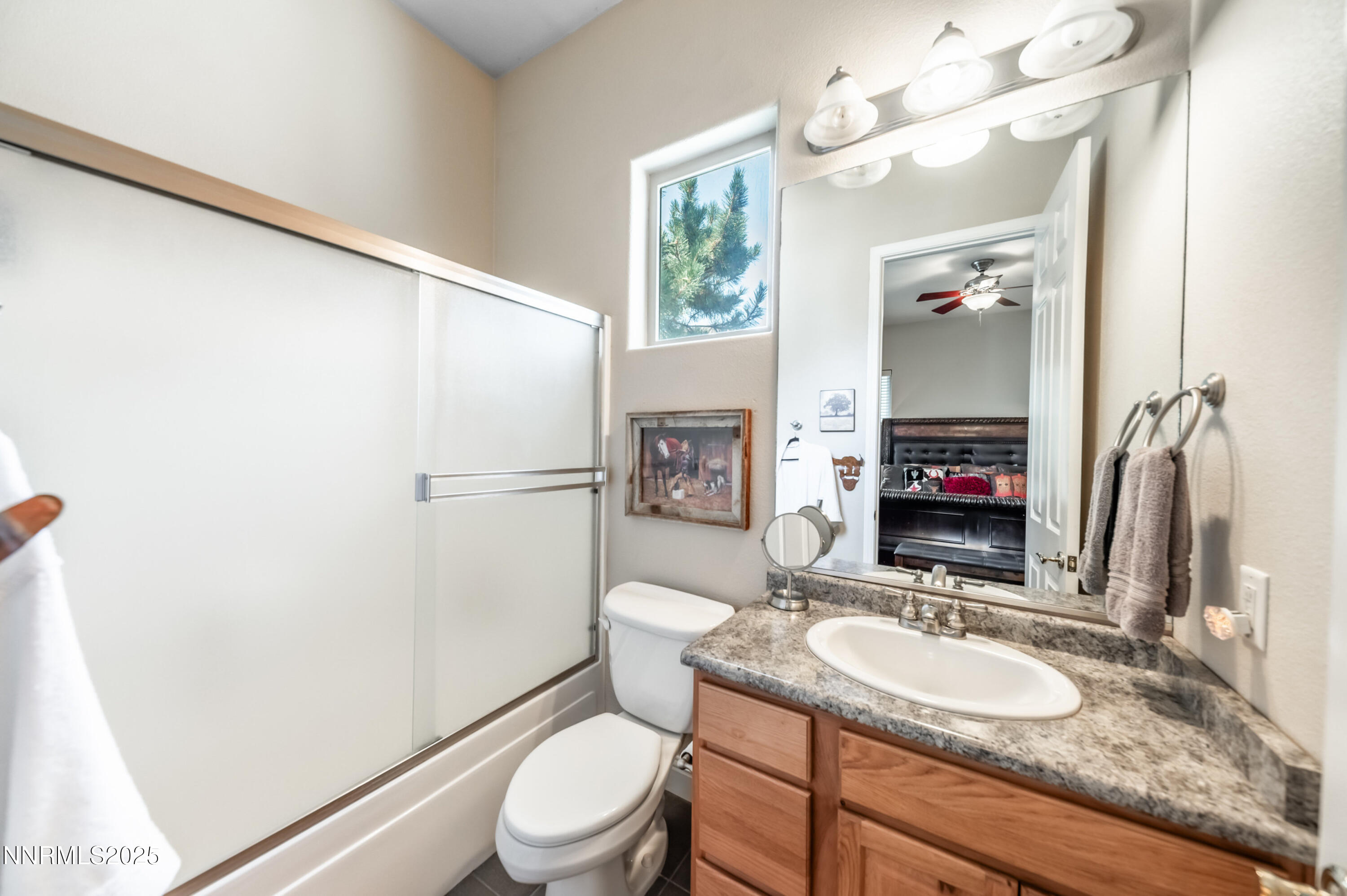 4433 Casey Road Fallon, NV 89406 - Photo 43 of 71 a bathroom with a granite countertop sink toilet a mirror and shower