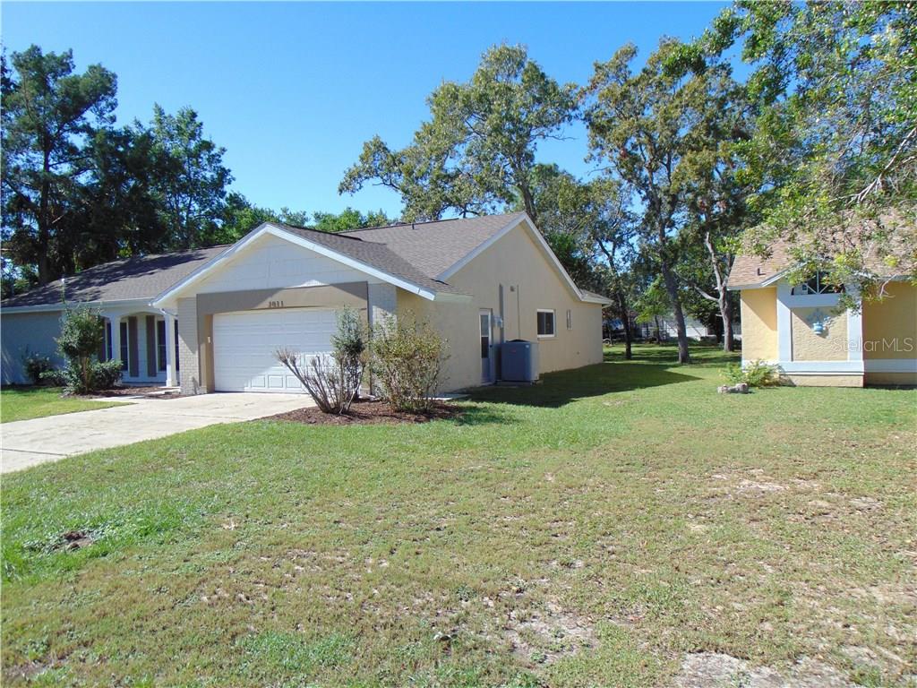 2011 Carson Avenue Spring Hill, FL 34608 - Photo 1 of 1 a view of a house with a yard