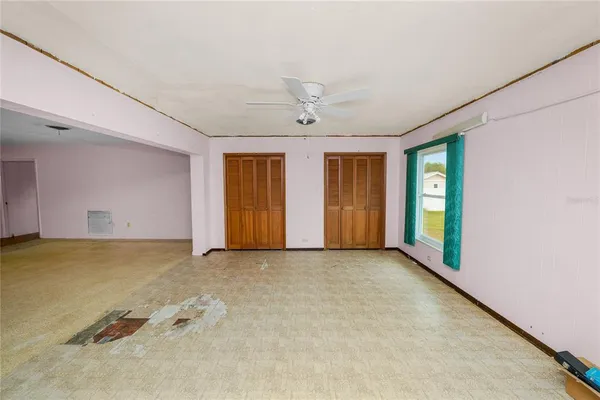 an empty room with a empty space and windows