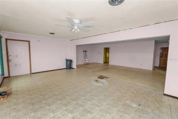 an empty room with windows and closet