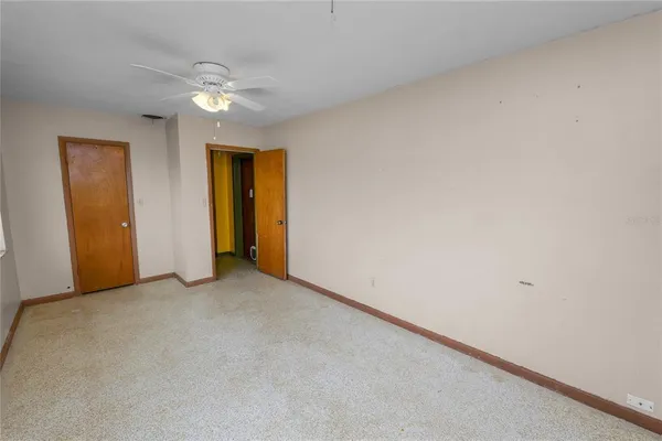 an empty room with closet and entryway