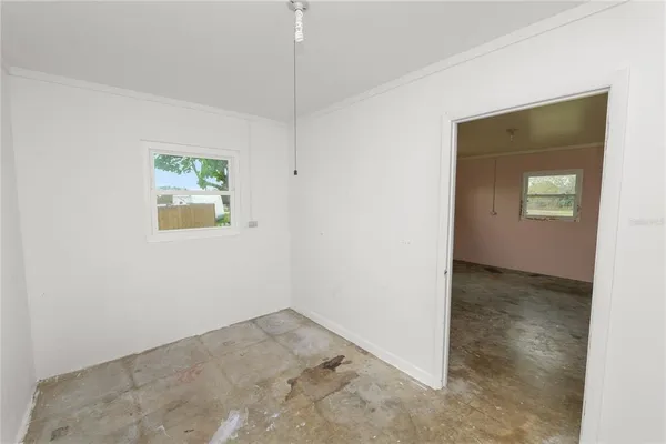 an empty room with a painting on the wall