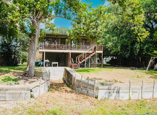 a view of a house with yard and sitting area