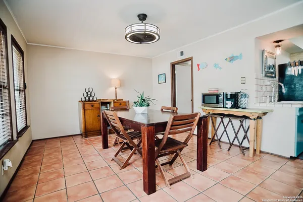 a dining room with furniture and window
