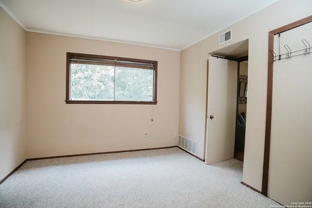 an empty room with windows and door