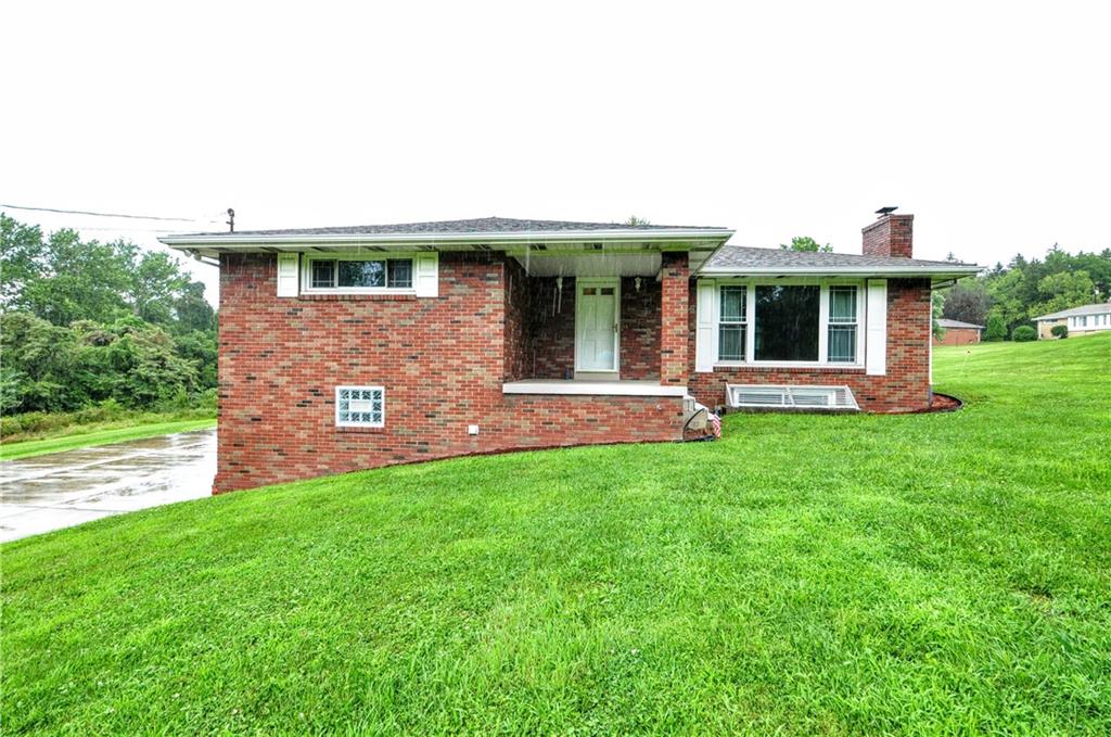 185 Highway 31 Ruffs Dale, PA 15679 - Photo 1 of 25 a front view of a house with garden