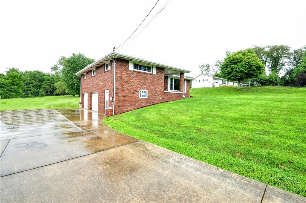 185 Highway 31 Ruffs Dale, PA 15679 - Photo 3 of 25 a front view of a house with a yard
