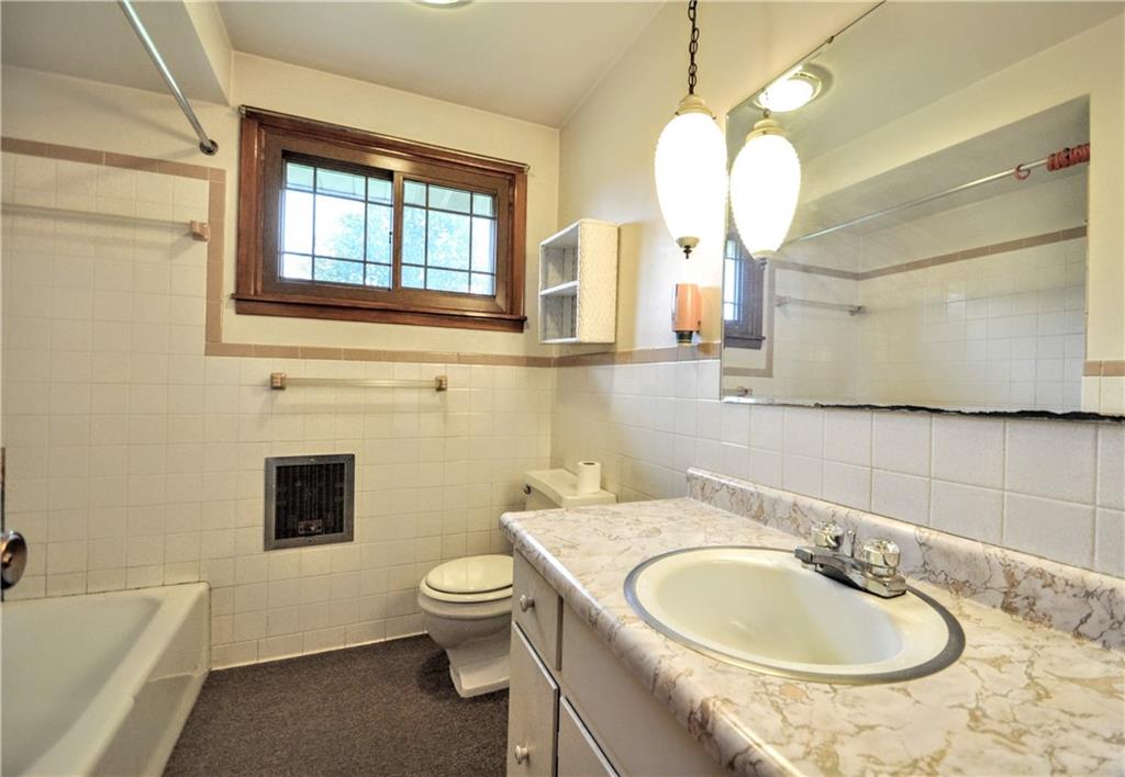 185 Highway 31 Ruffs Dale, PA 15679 - Photo 10 of 25 a bathroom with a sink a toilet and a mirror