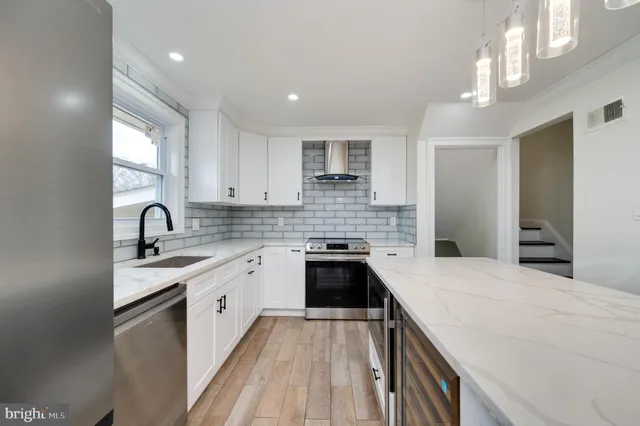 a kitchen with a sink cabinets and stainless steel appliances