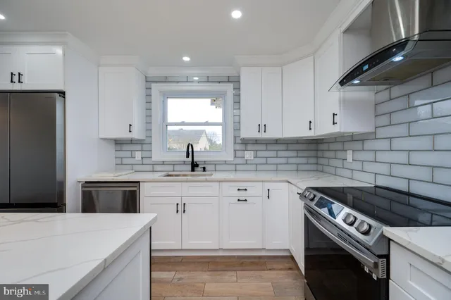 a kitchen with a stove sink and refrigerator