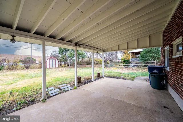 a view of a porch with furniture and garden