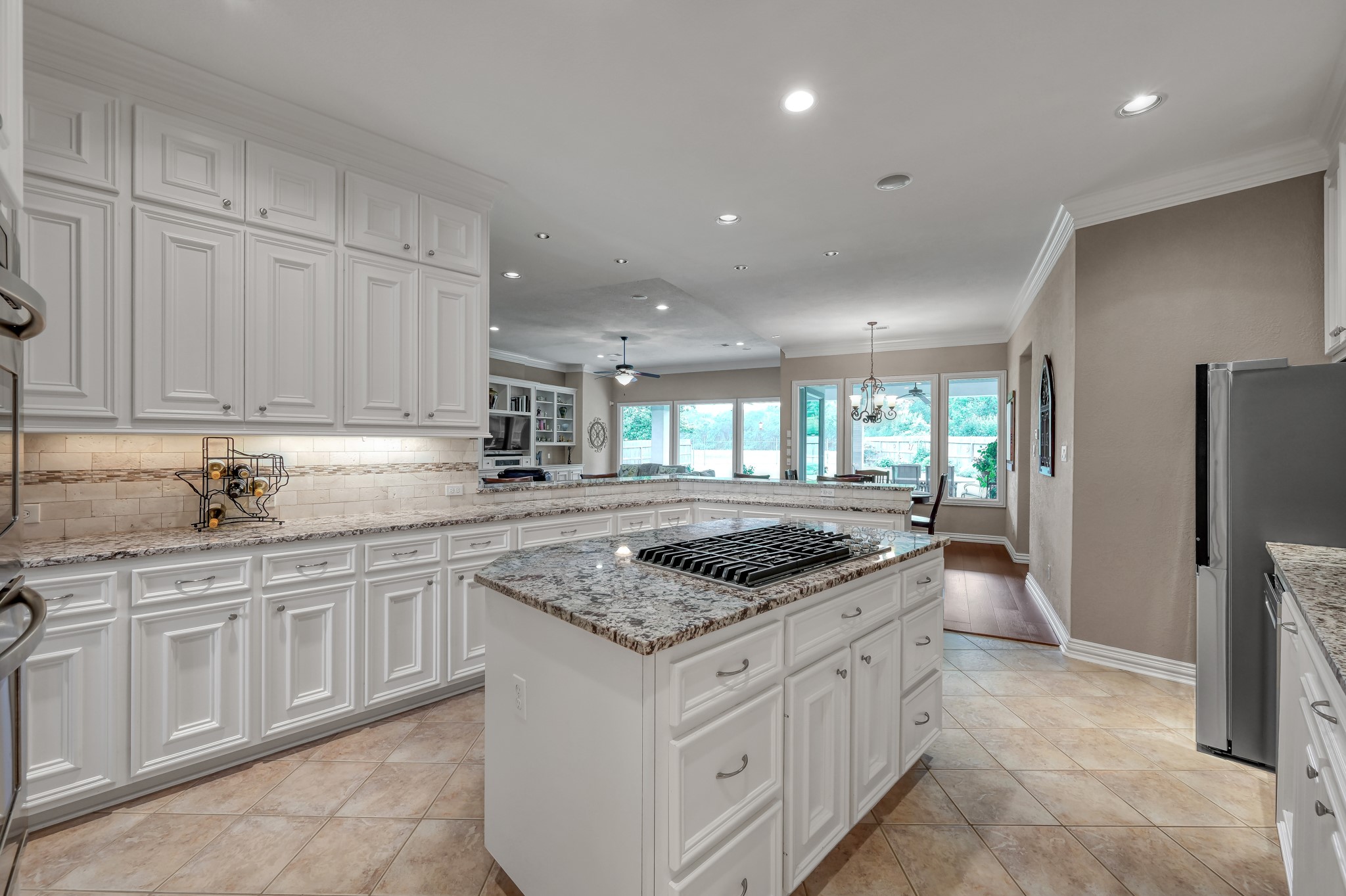 16318 Perry Pass Court Spring, TX 77379 - Photo 14 of 49 The custom cabinetry goes to the ceiling and is adorned by brushed nickel hardware. Plenty of storage in this kitchen! There is recessed and undercabinet lighting making the space light and bright!