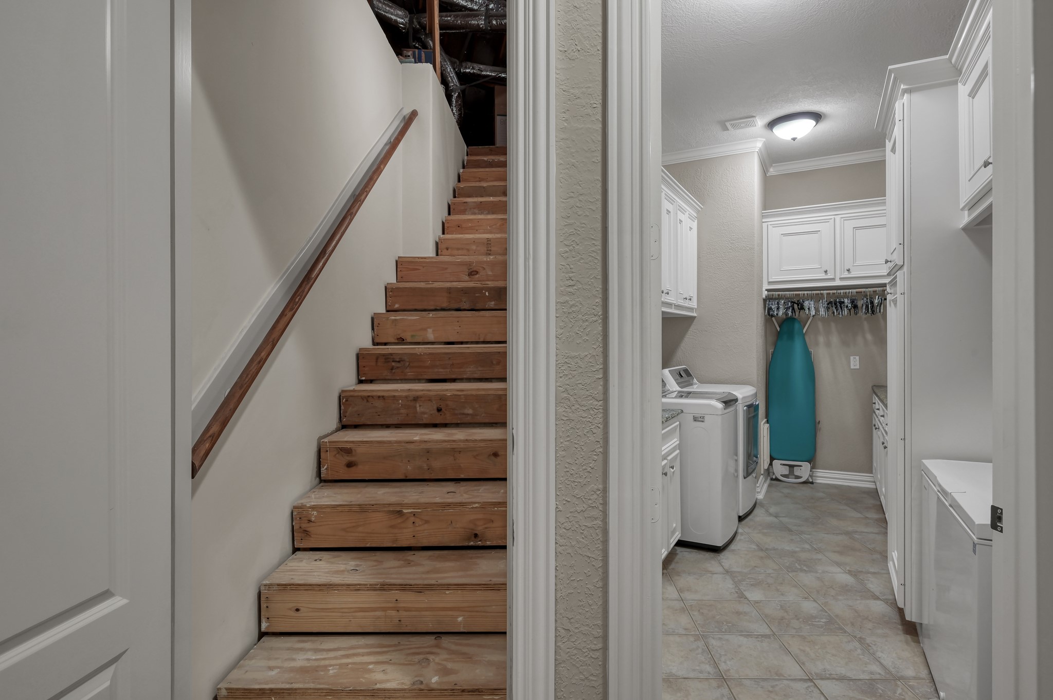 16318 Perry Pass Court Spring, TX 77379 - Photo 18 of 49 This wide set of stairs leads to the attic and a floored section for extra storage. It is located in the hallway leading to the garage.