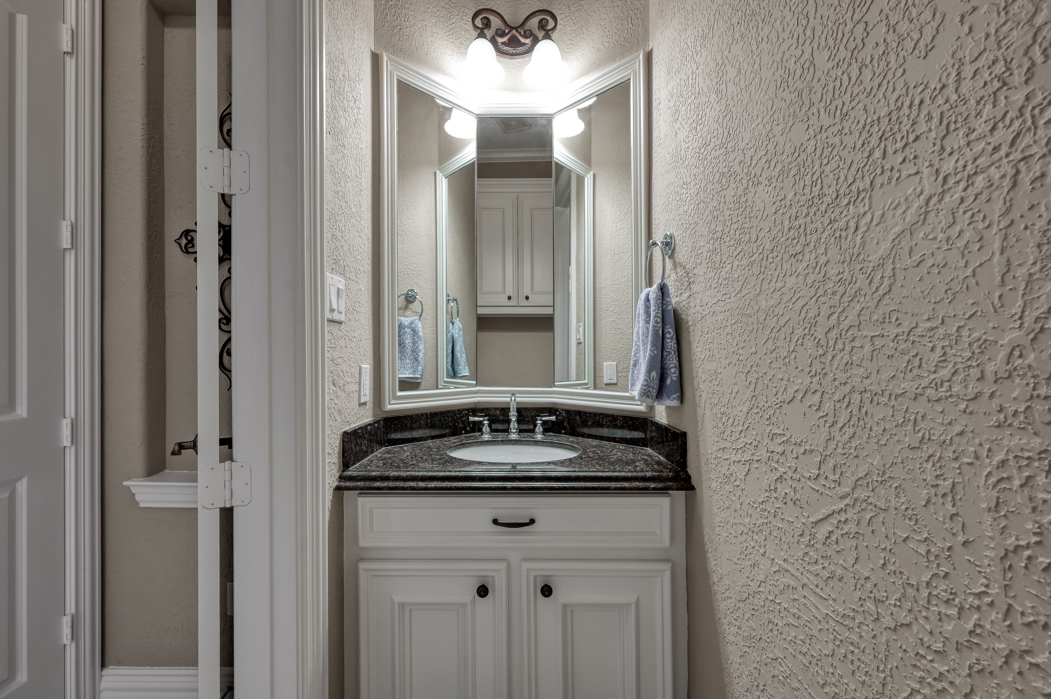 16318 Perry Pass Court Spring, TX 77379 - Photo 20 of 49 This half bath is convenient to the family gathering space and perfect for guests. There is a granite countertop and framed mirror.