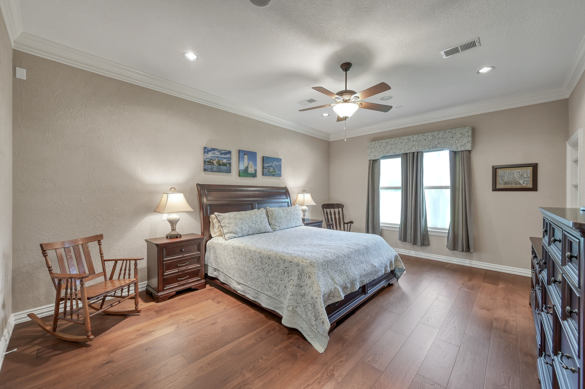 16318 Perry Pass Court Spring, TX 77379 - Photo 21 of 49 The oversized primary suite has wood floors, recessed lighting and a sitting area with views of the backyard.