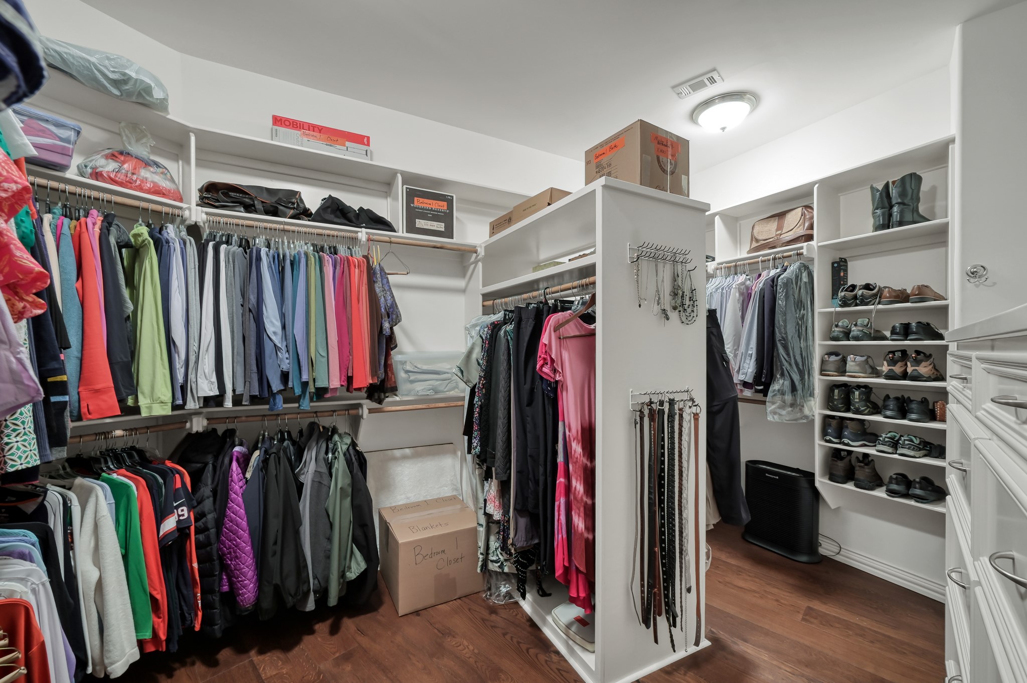 16318 Perry Pass Court Spring, TX 77379 - Photo 25 of 49 The expansive custom walk-in closet has ample shelving and dual built-in dressers.