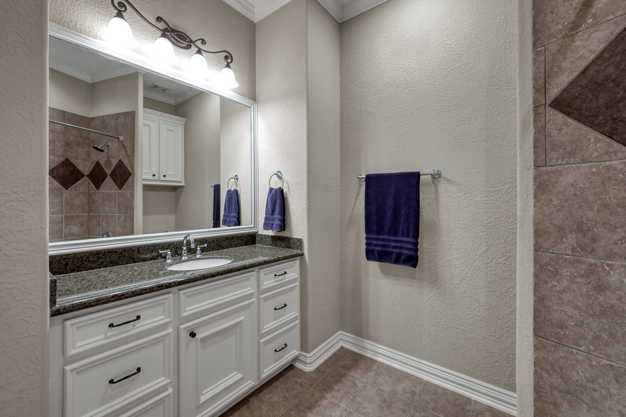 16318 Perry Pass Court Spring, TX 77379 - Photo 27 of 49 This bathroom has tile floors, a large vanity with a granite counter top and a framed mirror. The tub/shower combo has a six foot tub.