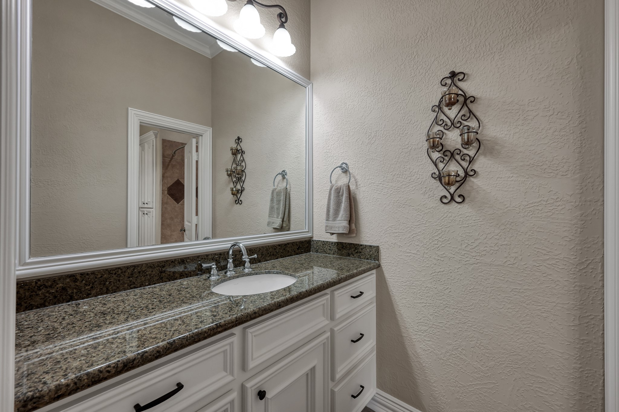 16318 Perry Pass Court Spring, TX 77379 - Photo 30 of 49 There is another large vanity in the third full bath with a granite countertop and framed mirror. This bathroom has a tub/shower combo and built-in linen cabinet for additional storage.