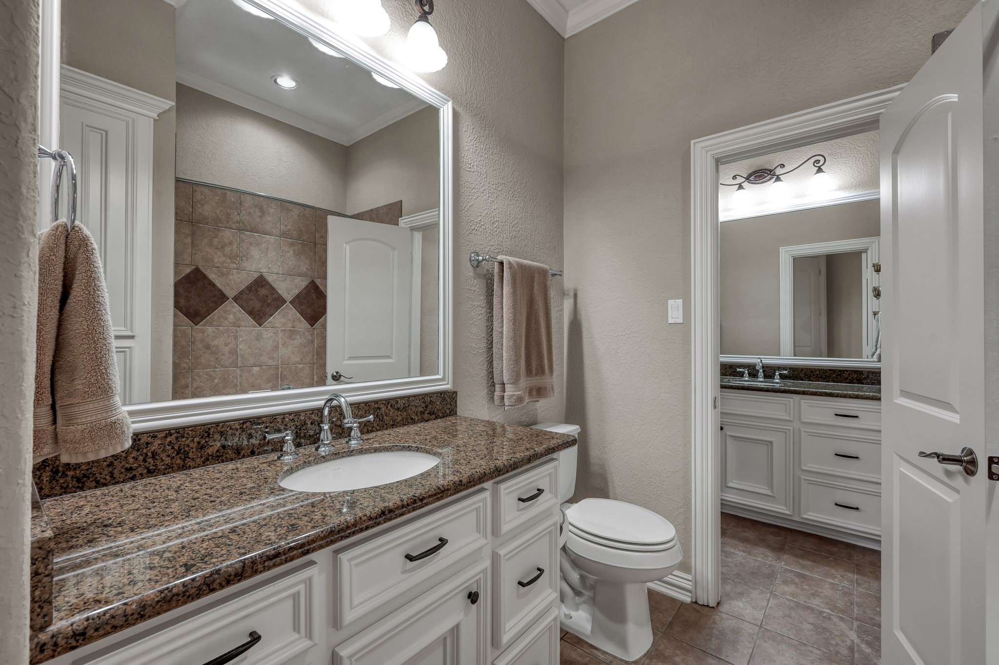 16318 Perry Pass Court Spring, TX 77379 - Photo 31 of 49 This bathroom has an additional sink and leads to the hallway and access for guests.