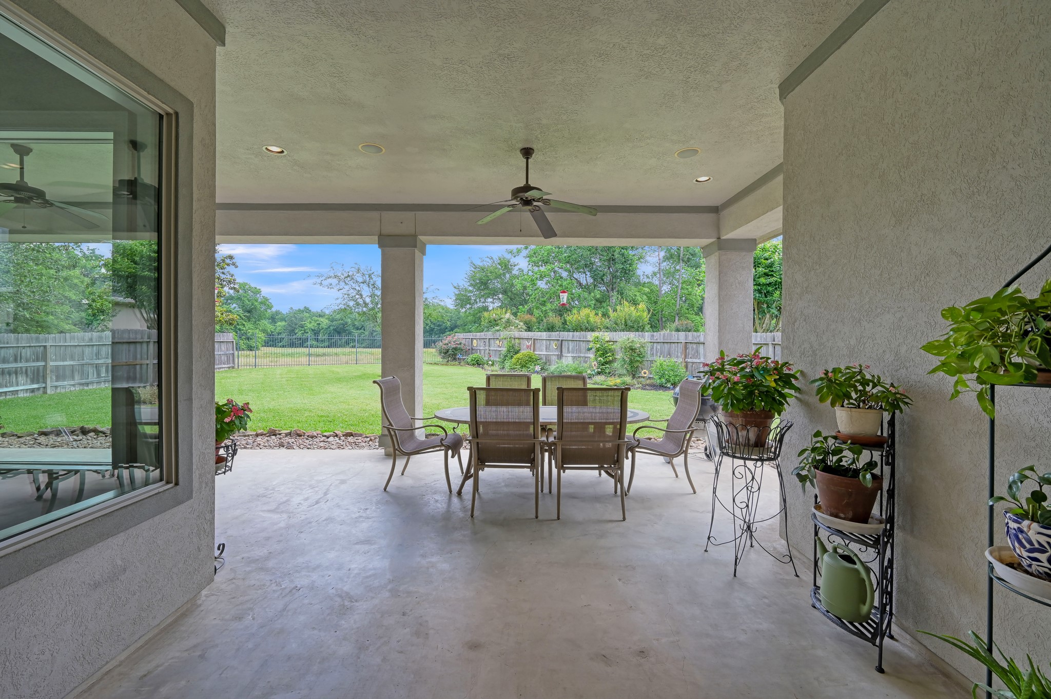 16318 Perry Pass Court Spring, TX 77379 - Photo 32 of 49 Let's go outback! The extensive patio has several gathering spaces and great views of the greenspace through the wrought iron fence across the back.
