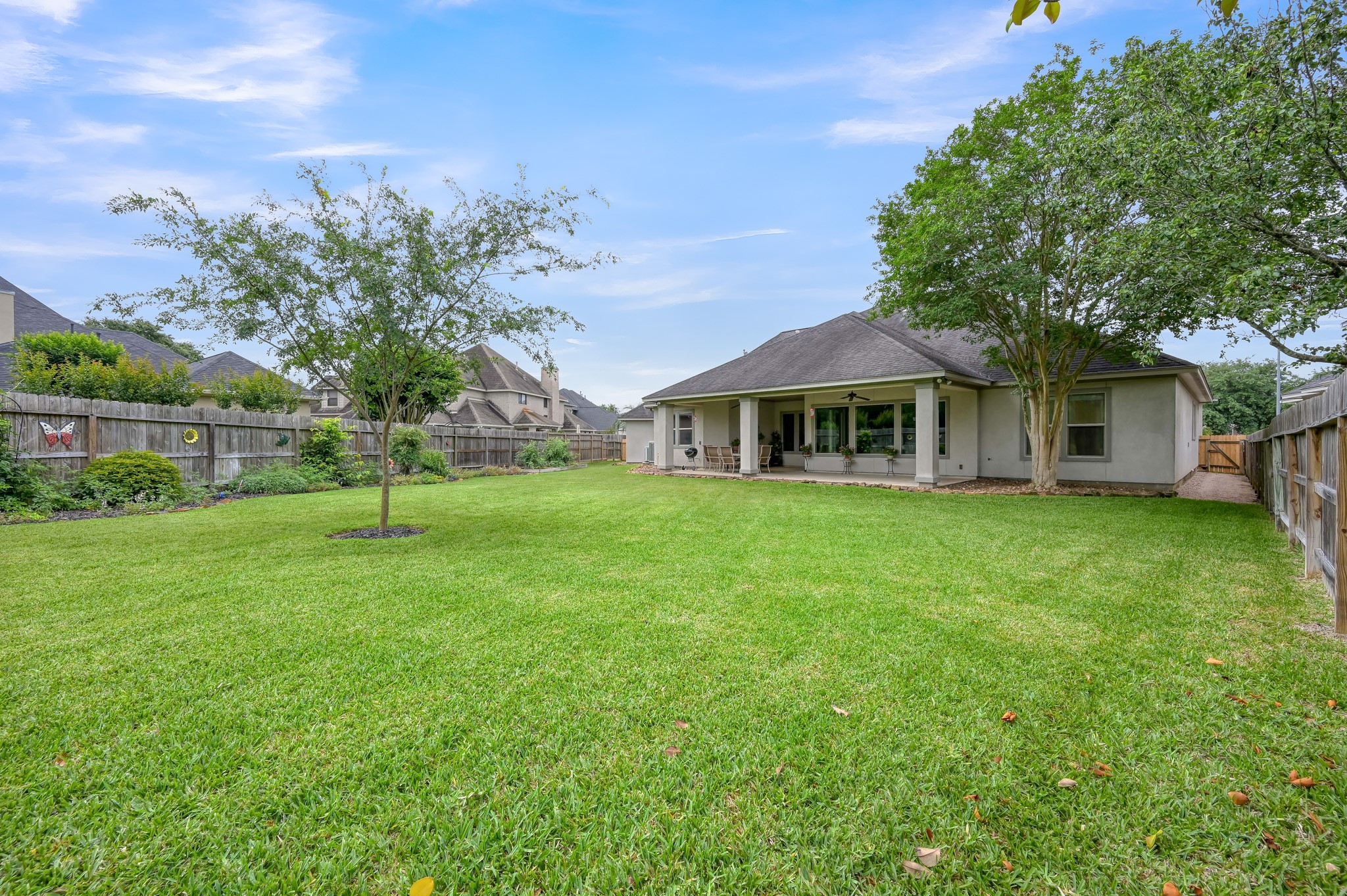 16318 Perry Pass Court Spring, TX 77379 - Photo 34 of 49 The oversized backyard has lush grass and well landscaped with raised beds for a vegetable garden. The established tomato plants are already bearing fruit!