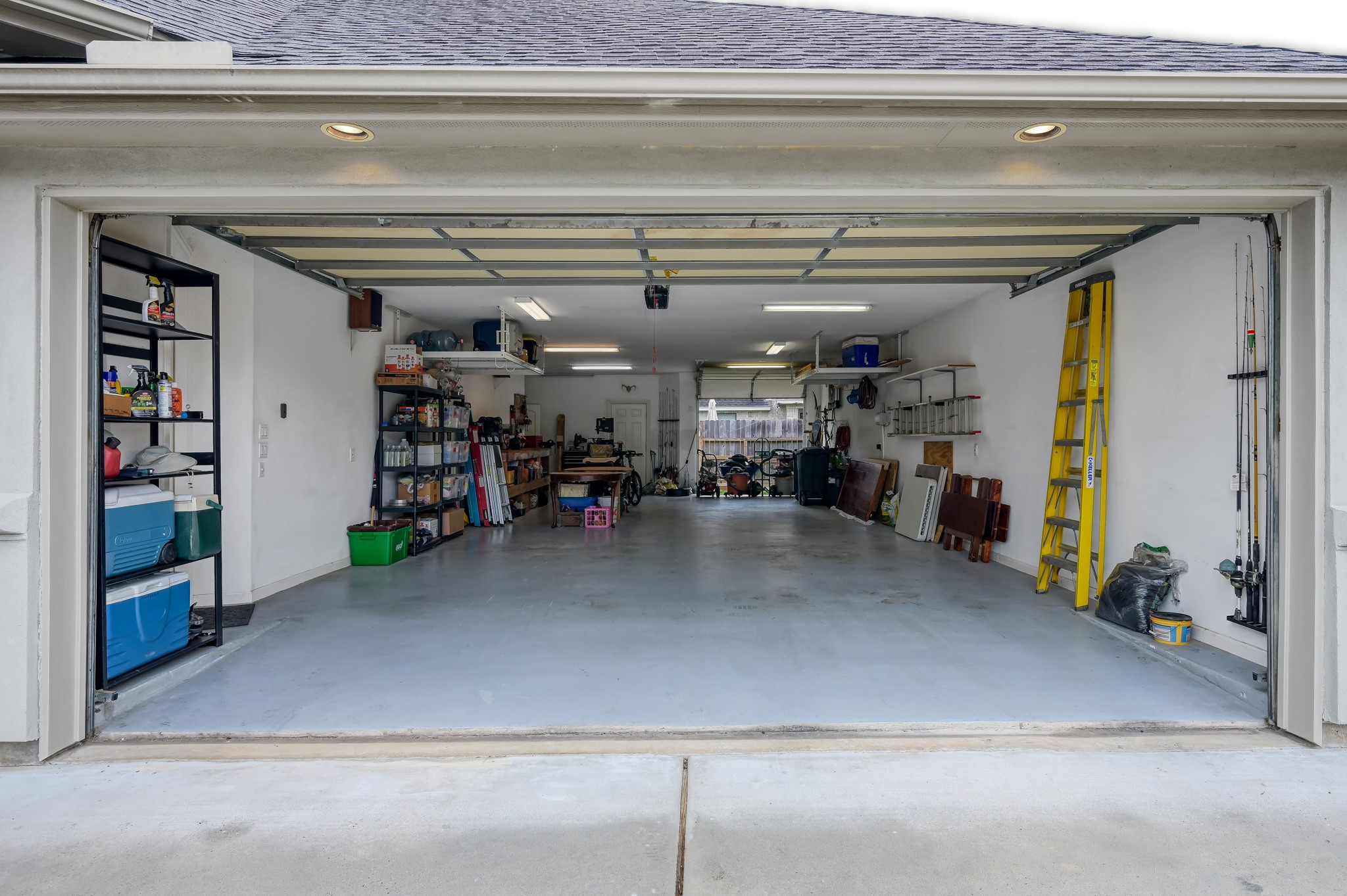 16318 Perry Pass Court Spring, TX 77379 - Photo 36 of 49 This oversized four car garage was set-up for car enthusiasts and a workshop. There is an overhead and rear door at the back with access to the side and backyard.