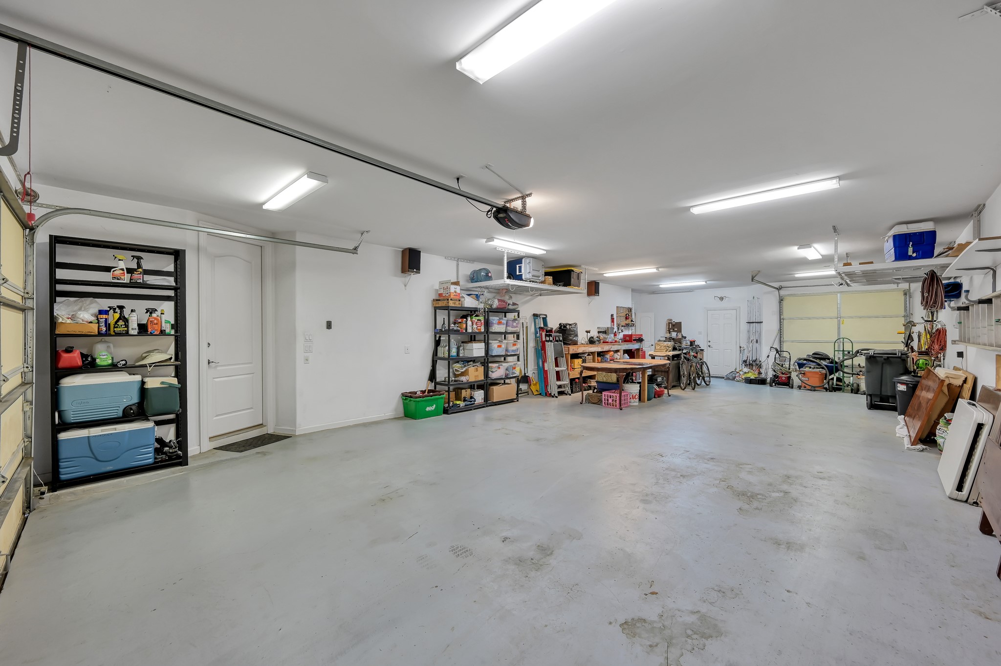 16318 Perry Pass Court Spring, TX 77379 - Photo 37 of 49 There are two large overhead storage racks plus seven shop lights!