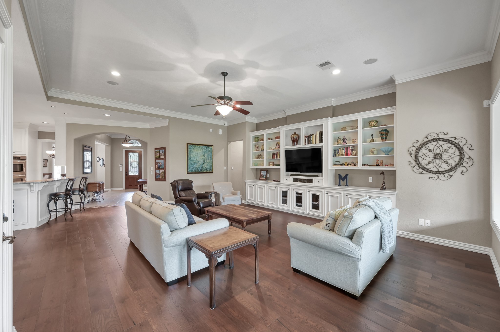 16318 Perry Pass Court Spring, TX 77379 - Photo 9 of 49 This view is from the back of the family room looking toward the entry and dining area. The hallway to the right leads to the private primary suite that is separate from the secondary bedrooms.