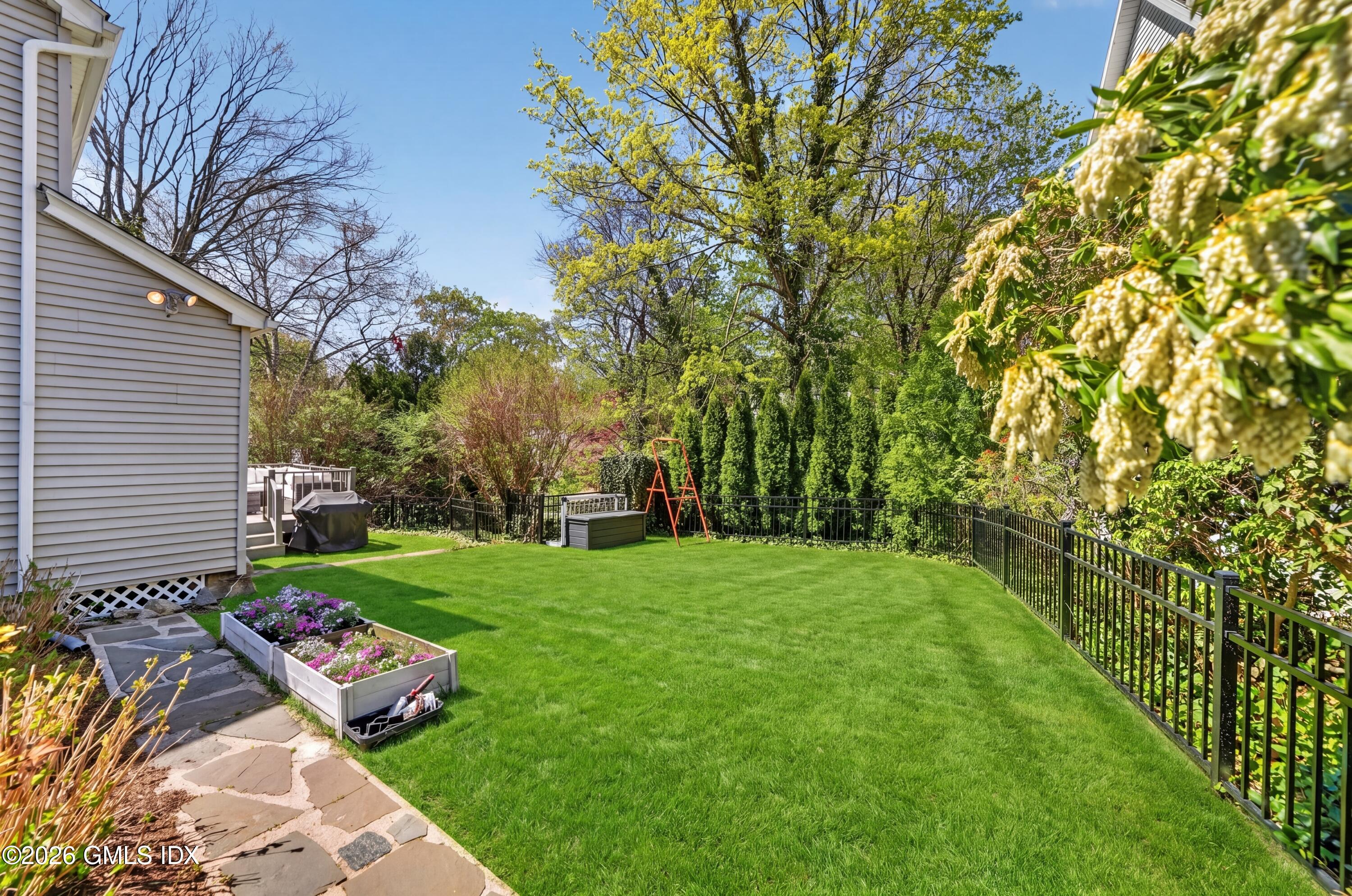 20 Ridge Road Cos Cob, CT 06807 - Photo 35 of 36 a view of a backyard with plants and large trees