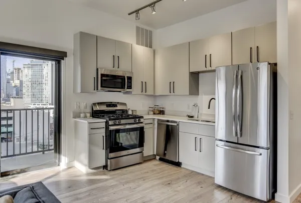 a kitchen with stainless steel appliances a refrigerator sink and microwave