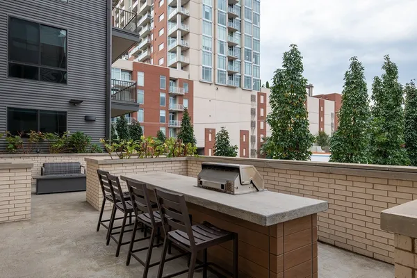 a view of a patio with a table and chairs and potted plants