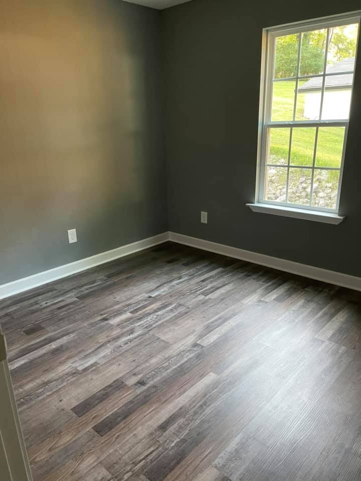 130 Main Street South, Unit 1 Carthage, TN 37030 - Photo 6 of 9 a view of an empty room with wooden floor and a window